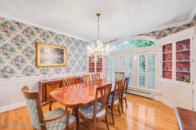 a view of a hallway with wooden floor and windows