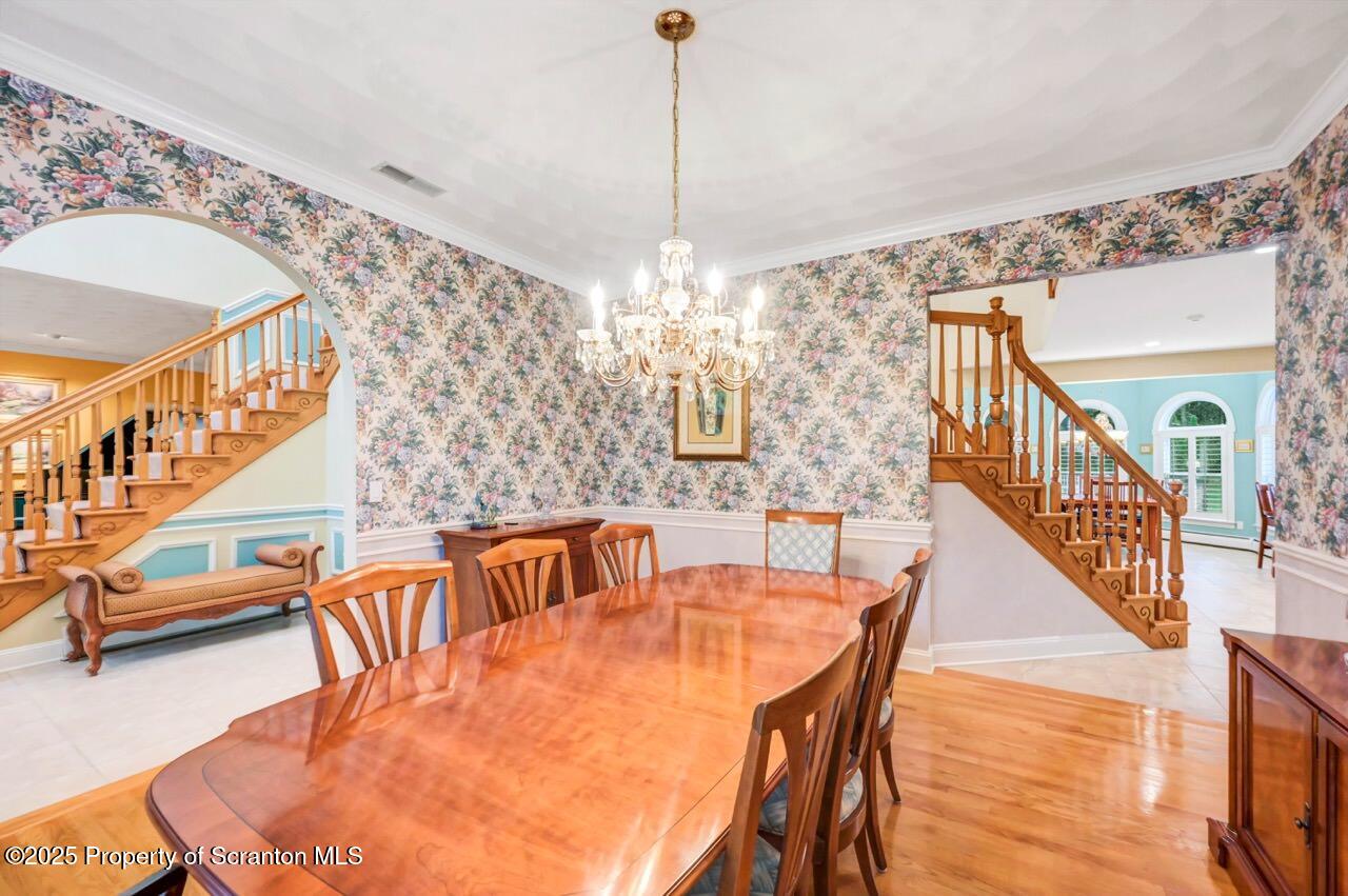 922 Old Logger Road Moscow, PA 18444 - Photo 33 of 93 a dining room with furniture a chandelier and wooden floor