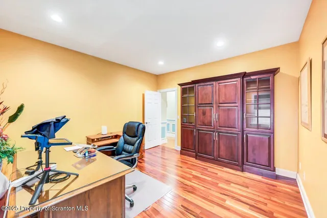 a view of an empty room with stairs and a living room view