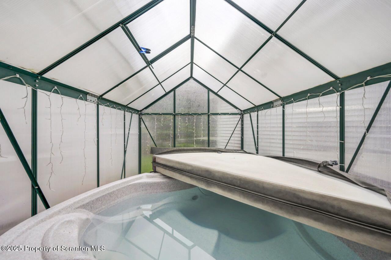 922 Old Logger Road Moscow, PA 18444 - Photo 43 of 93 a bedroom with a bed a large window with outer view