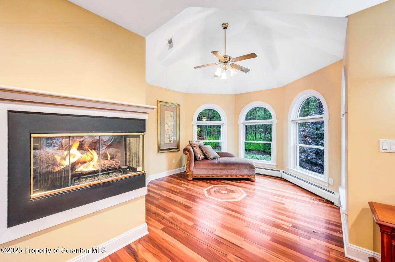 922 Old Logger Road Moscow, PA 18444 - Photo 51 of 93 a living room with furniture fireplace and wooden floor