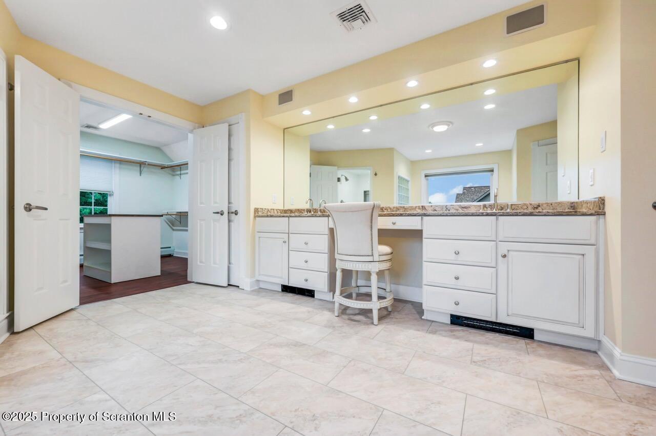922 Old Logger Road Moscow, PA 18444 - Photo 53 of 93 a kitchen with white cabinets and stainless steel appliances