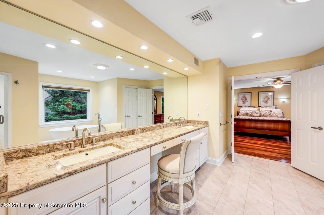 922 Old Logger Road Moscow, PA 18444 - Photo 54 of 93 a bathroom with a granite countertop sink and a large mirror