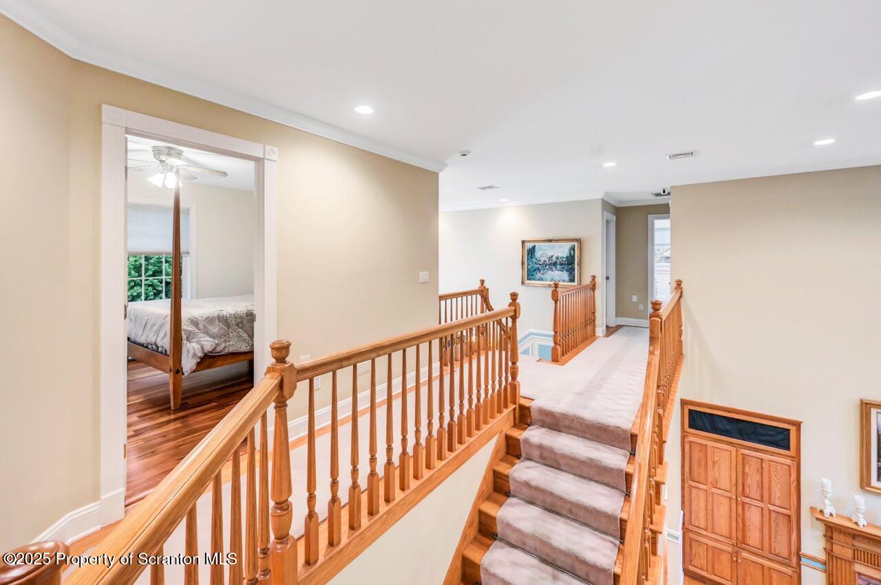 922 Old Logger Road Moscow, PA 18444 - Photo 58 of 93 a view of a hallway with wooden floor and windows