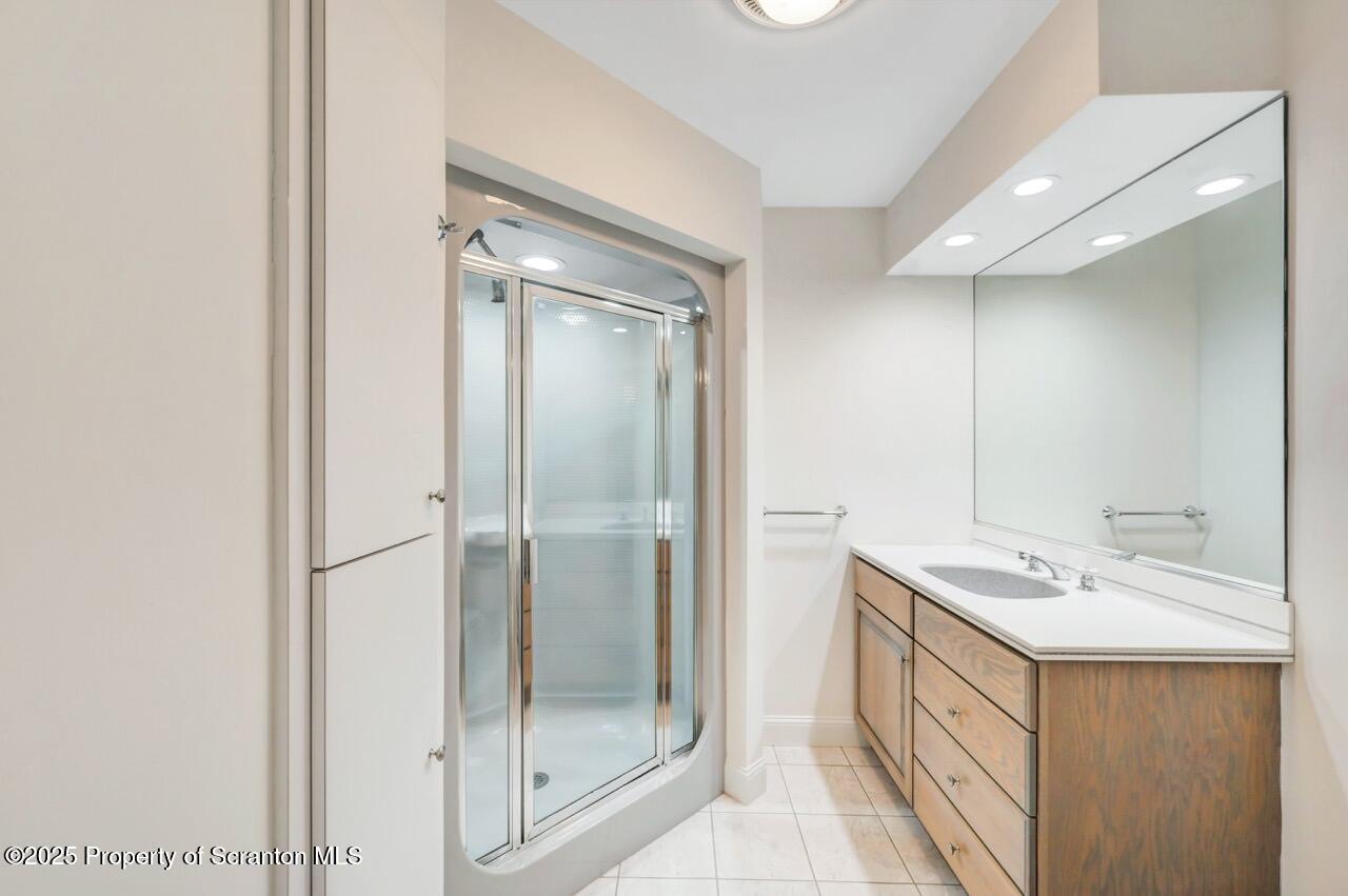 922 Old Logger Road Moscow, PA 18444 - Photo 61 of 93 a bathroom with a shower sink and mirror