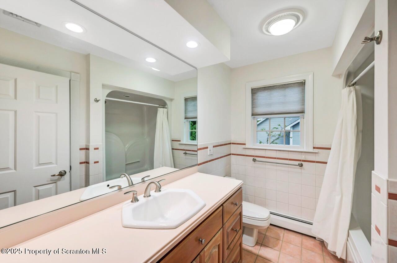 922 Old Logger Road Moscow, PA 18444 - Photo 64 of 93 a bathroom with a sink a toilet and shower