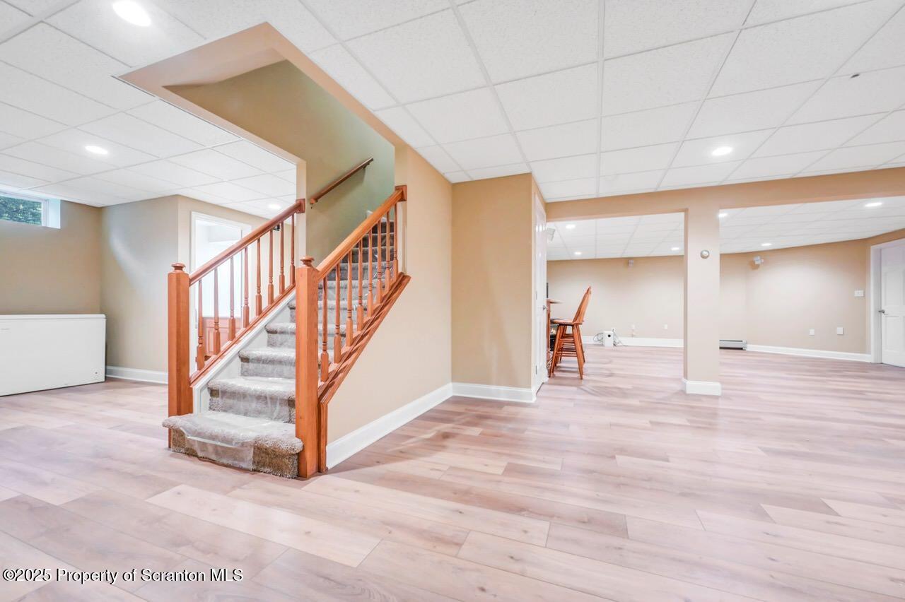 922 Old Logger Road Moscow, PA 18444 - Photo 72 of 93 a view of an empty room with stairs and a living room view
