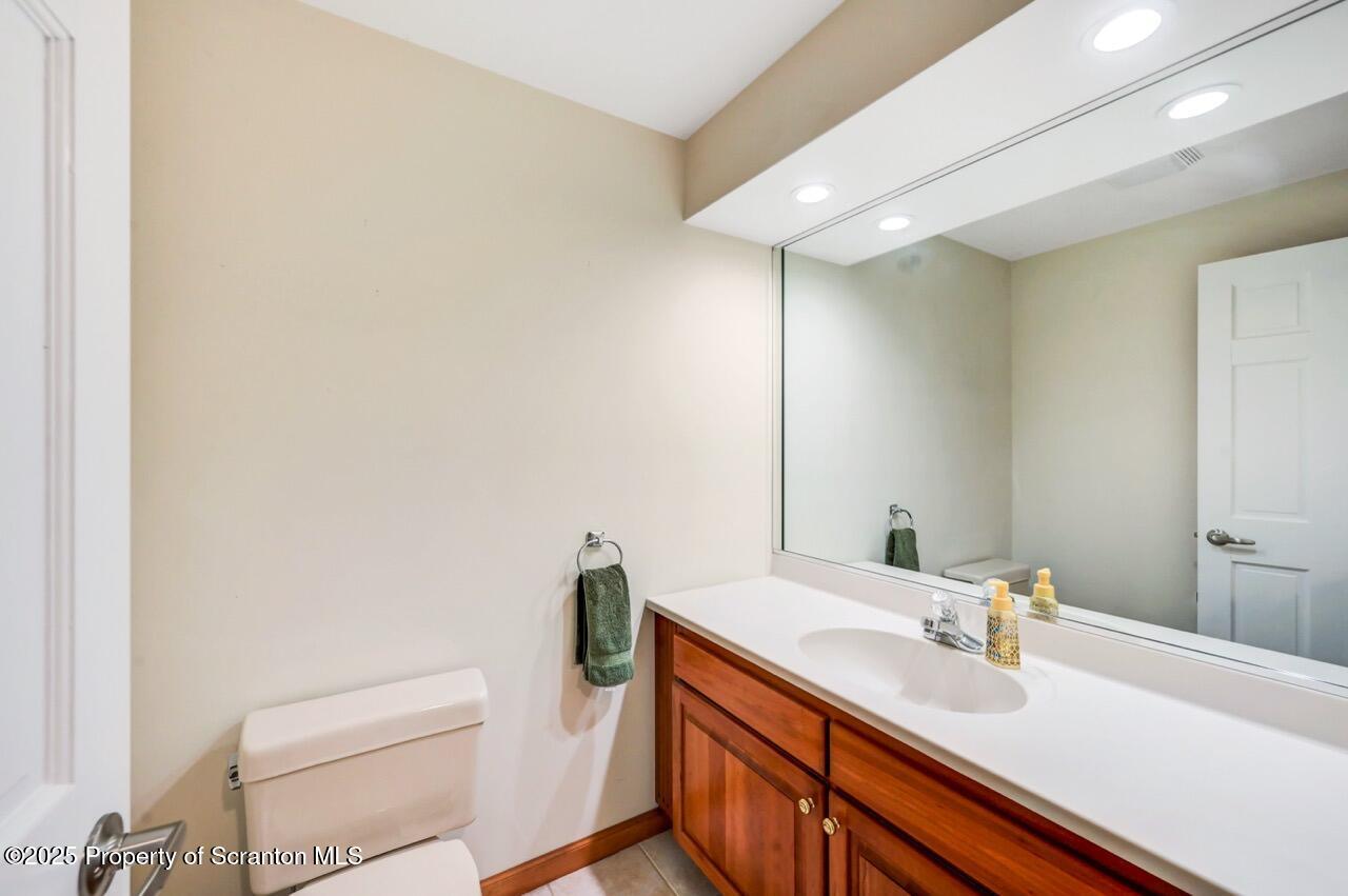 922 Old Logger Road Moscow, PA 18444 - Photo 78 of 93 a bathroom with a sink a toilet and a mirror
