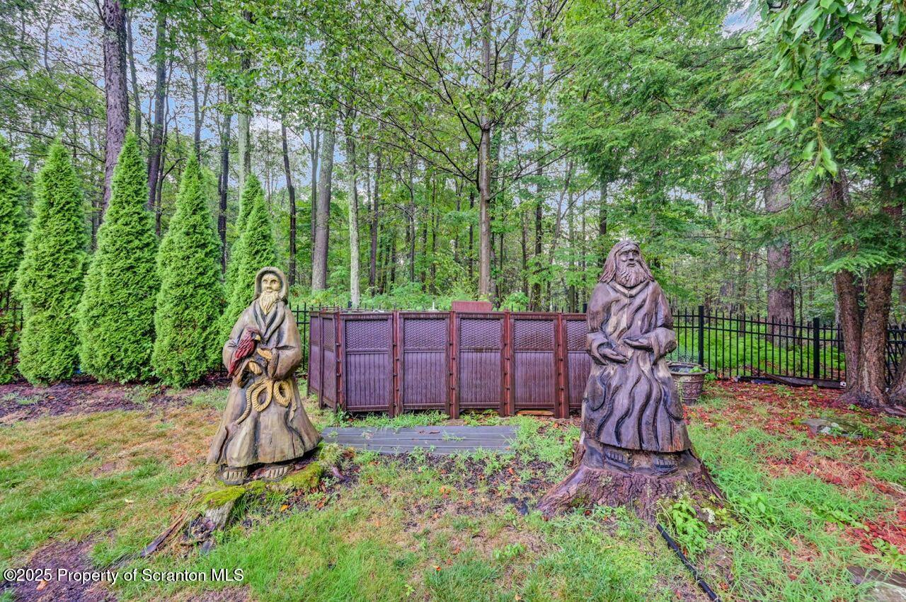 922 Old Logger Road Moscow, PA 18444 - Photo 90 of 93 a view of a backyard with a slide trees and wooden fence