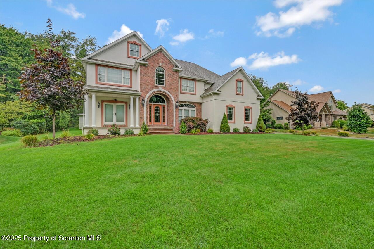 922 Old Logger Road Moscow, PA 18444 - Photo 93 of 93 a front view of a house with a garden and trees