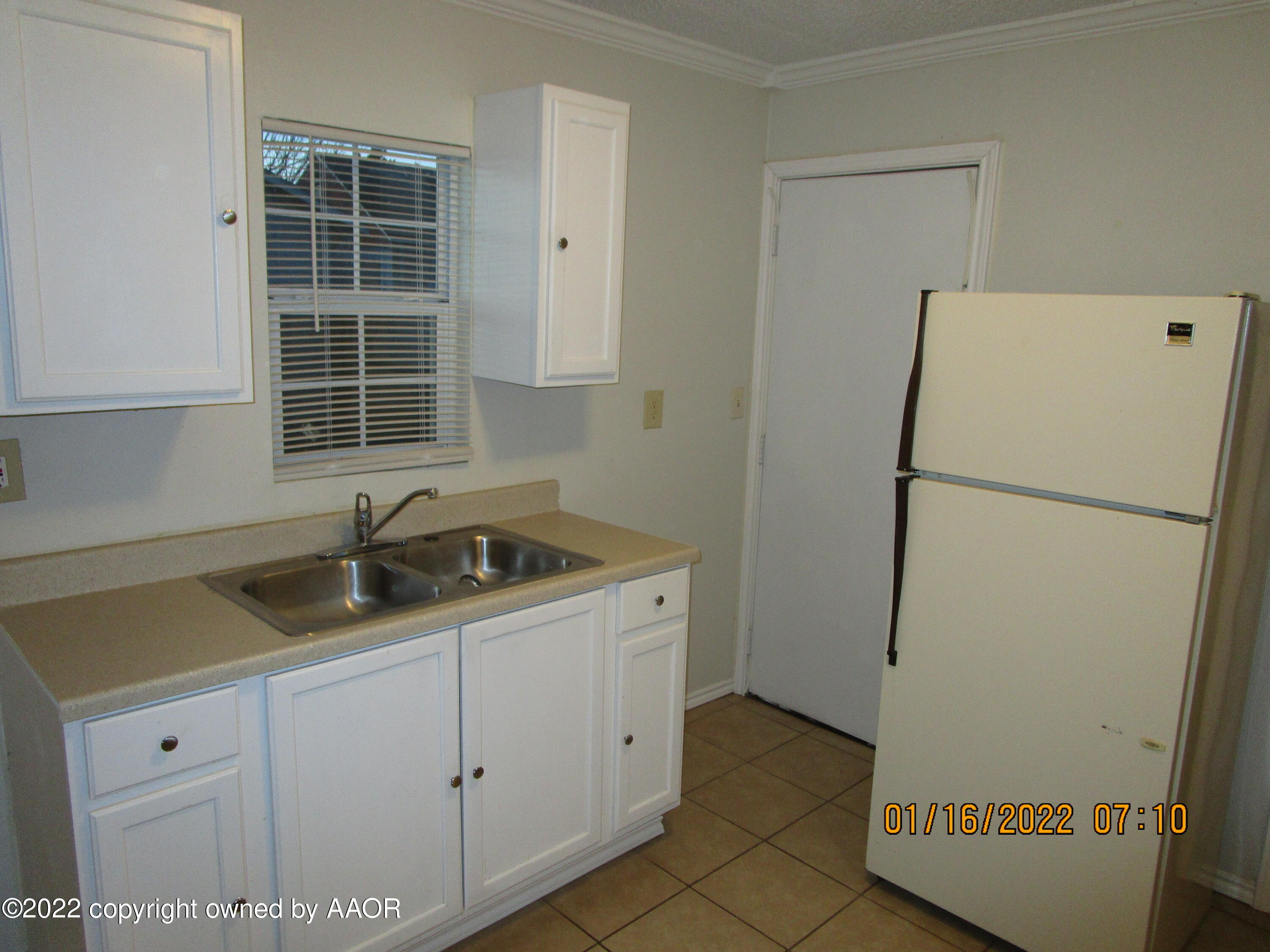 711 Wichita Avenue Amarillo, TX 79107 - Photo 3 of 6 a kitchen with a sink and a refrigerator