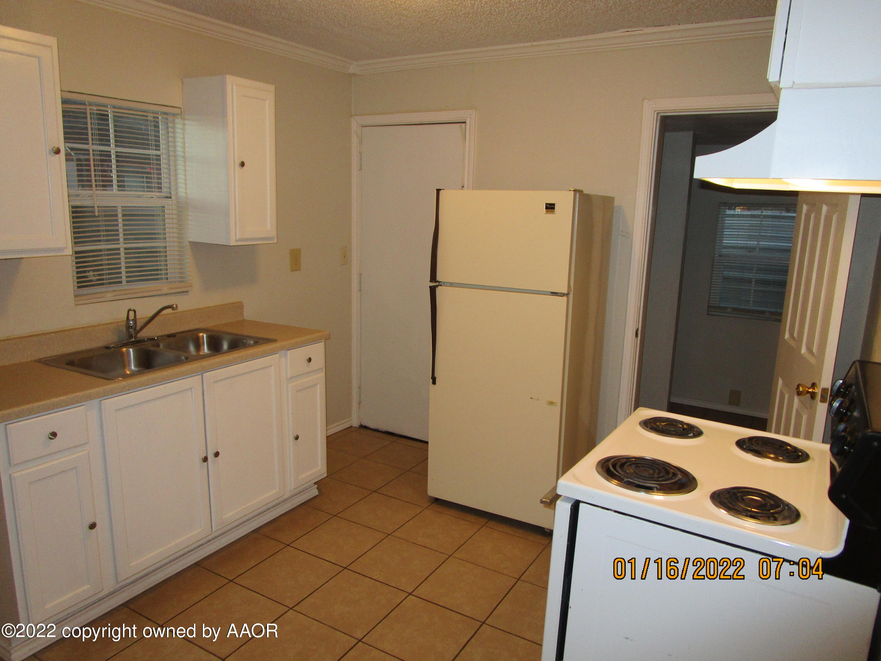 711 Wichita Avenue Amarillo, TX 79107 - Photo 4 of 6 a kitchen with a refrigerator and a sink