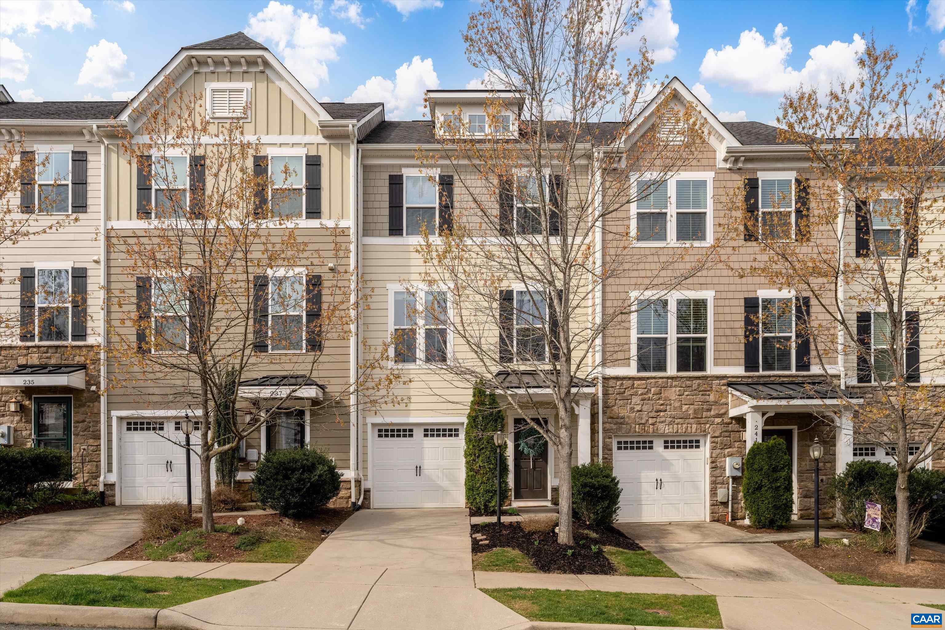 a front view of a residential apartment building with a yard