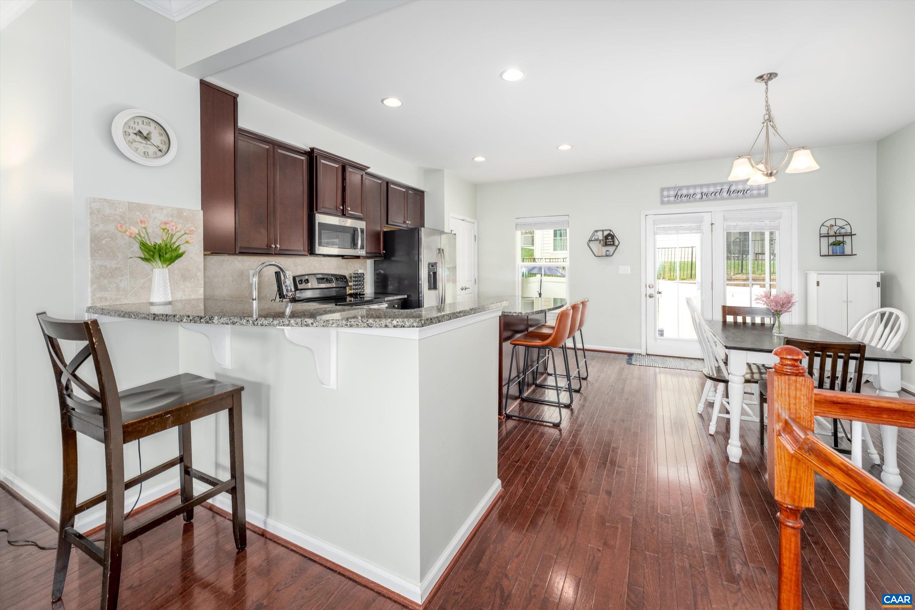 239 Pebble Beach Court Charlottesville, VA 22901 - Photo 16 of 57 a living room with stainless steel appliances kitchen island granite countertop wooden floor and a view of kitchen