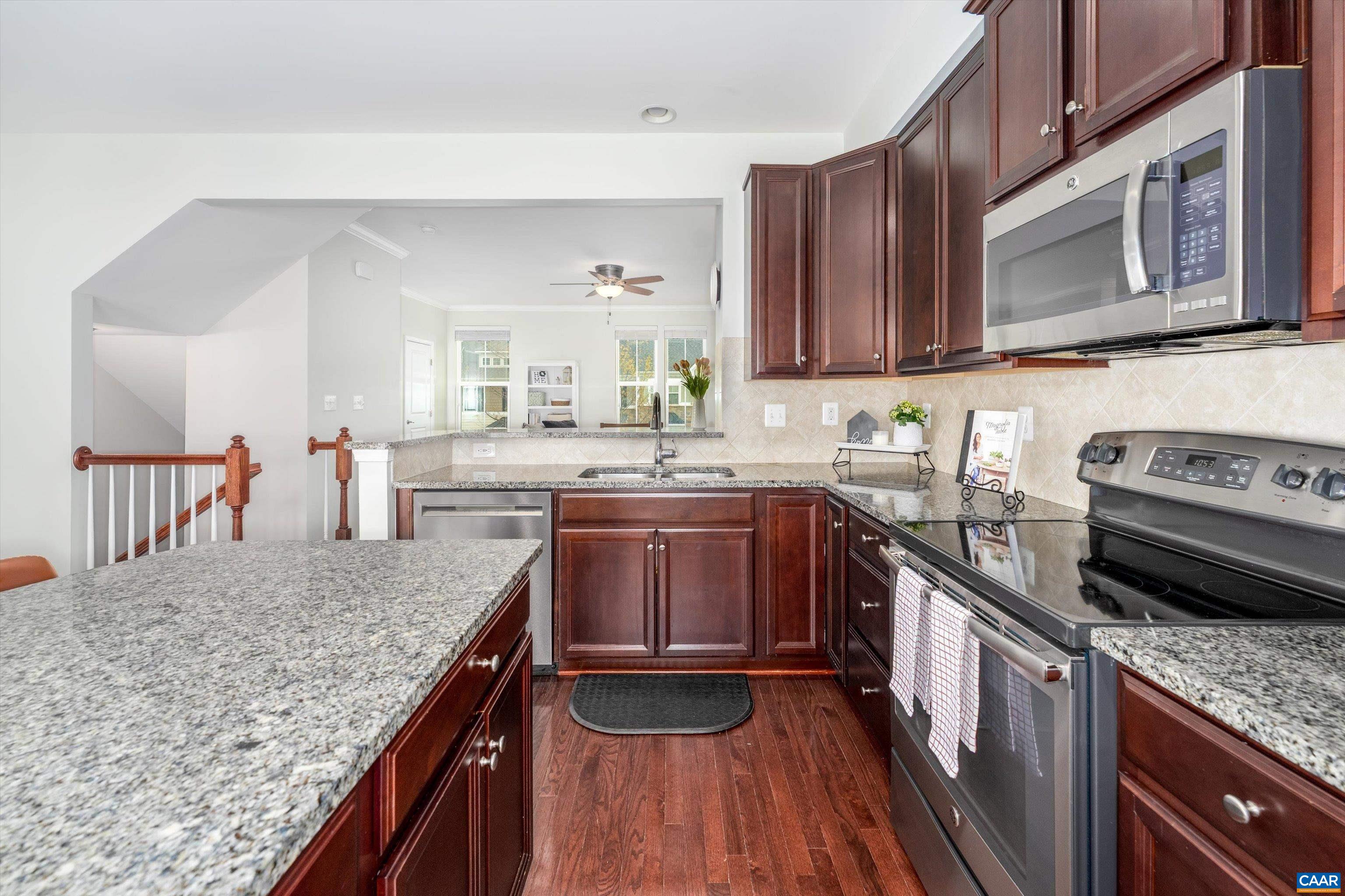 239 Pebble Beach Court Charlottesville, VA 22901 - Photo 19 of 57 a kitchen with stainless steel appliances granite countertop a stove sink microwave and cabinets