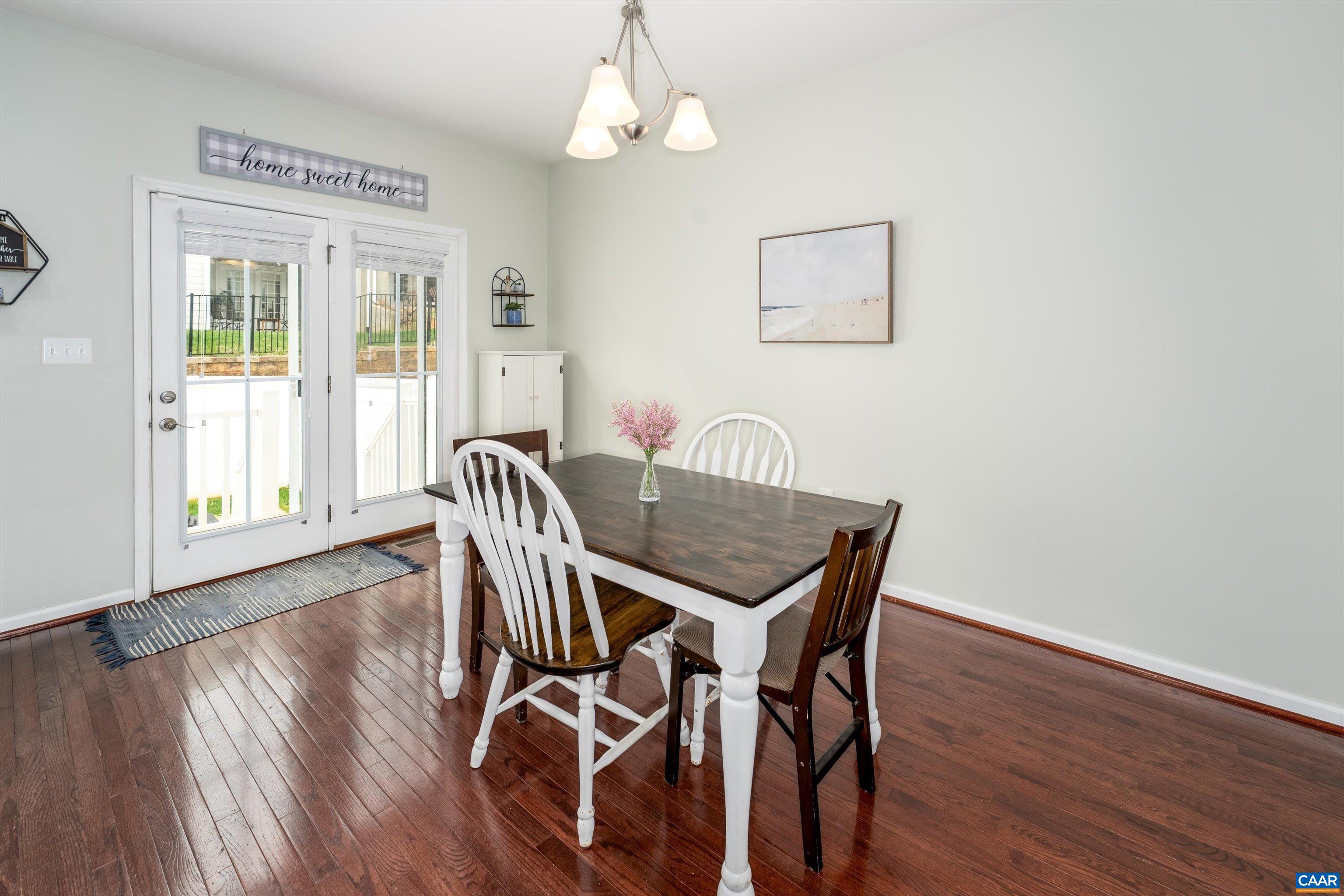 239 Pebble Beach Court Charlottesville, VA 22901 - Photo 25 of 57 a view of a dining room with furniture wooden floor and a chandelier