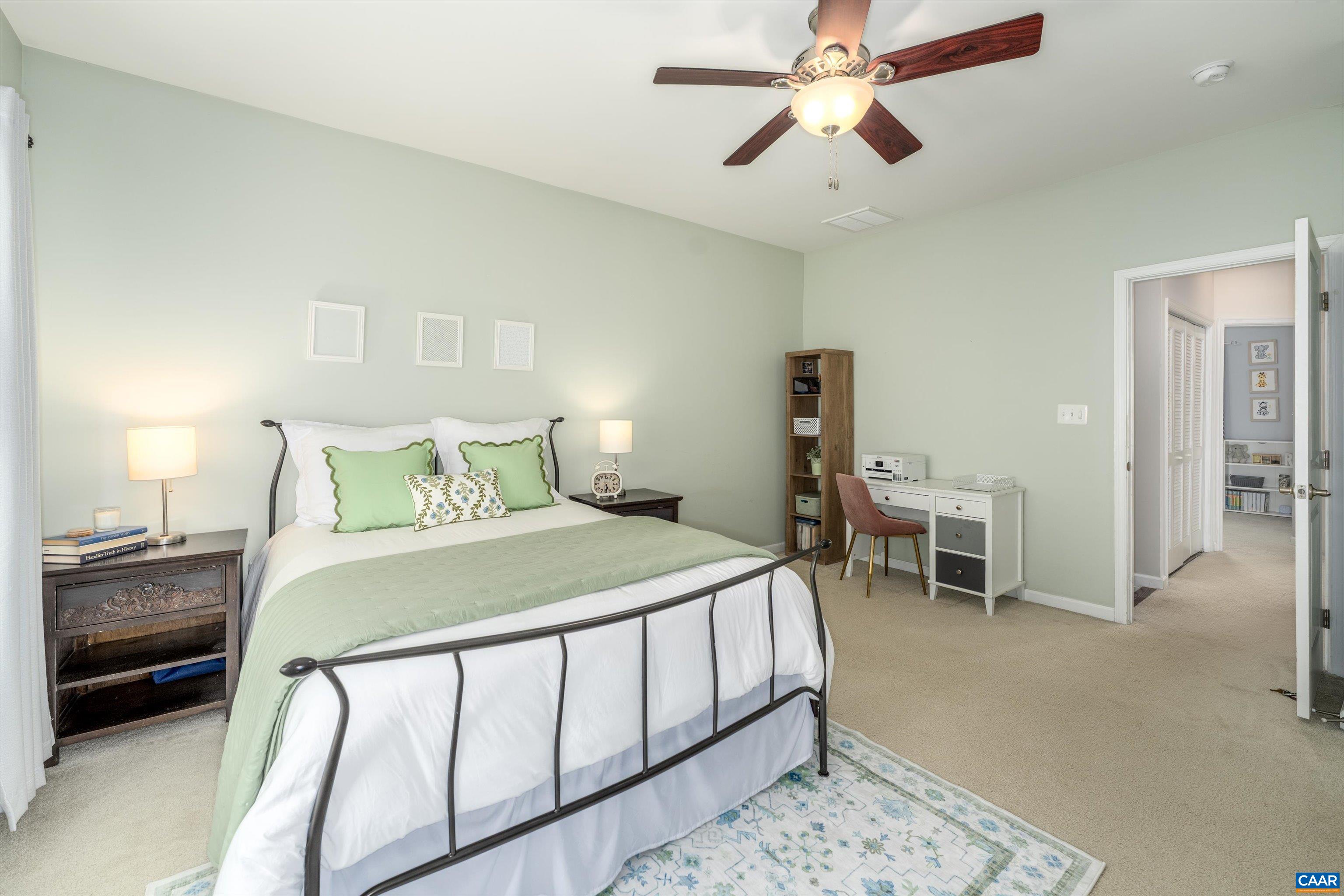 239 Pebble Beach Court Charlottesville, VA 22901 - Photo 37 of 57 a bedroom with a bed and a chandelier