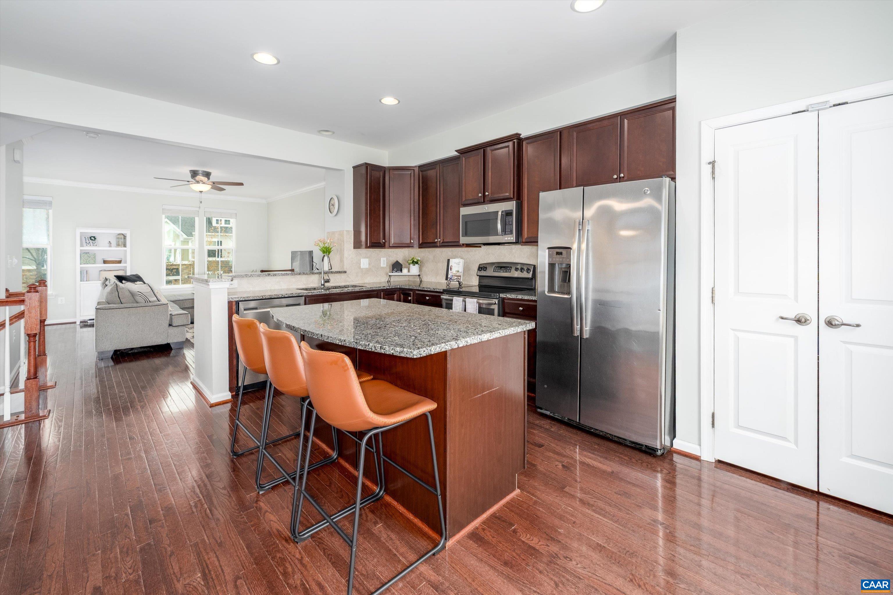 239 Pebble Beach Court Charlottesville, VA 22901 - Photo 4 of 57 a kitchen with stainless steel appliances granite countertop a refrigerator a sink dishwasher a stove with wooden floors and cabinets