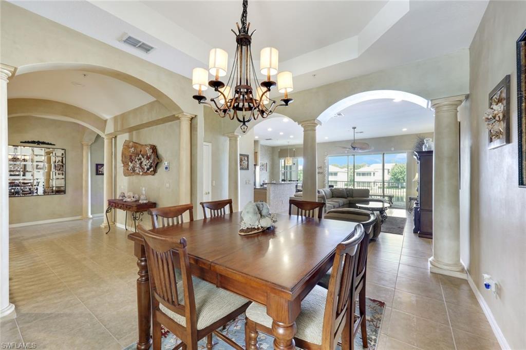 3530 Lansing Loop, Unit 202 Estero, FL 33928 - Photo 18 of 35 a view of a dining room and chandelier
