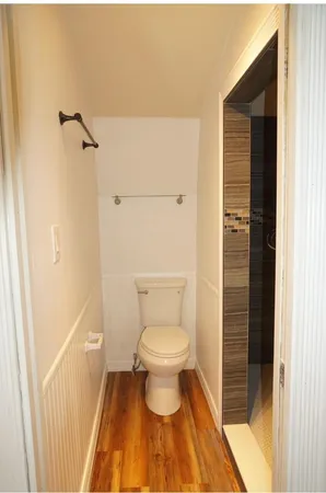 a bathroom with a toilet and a shower