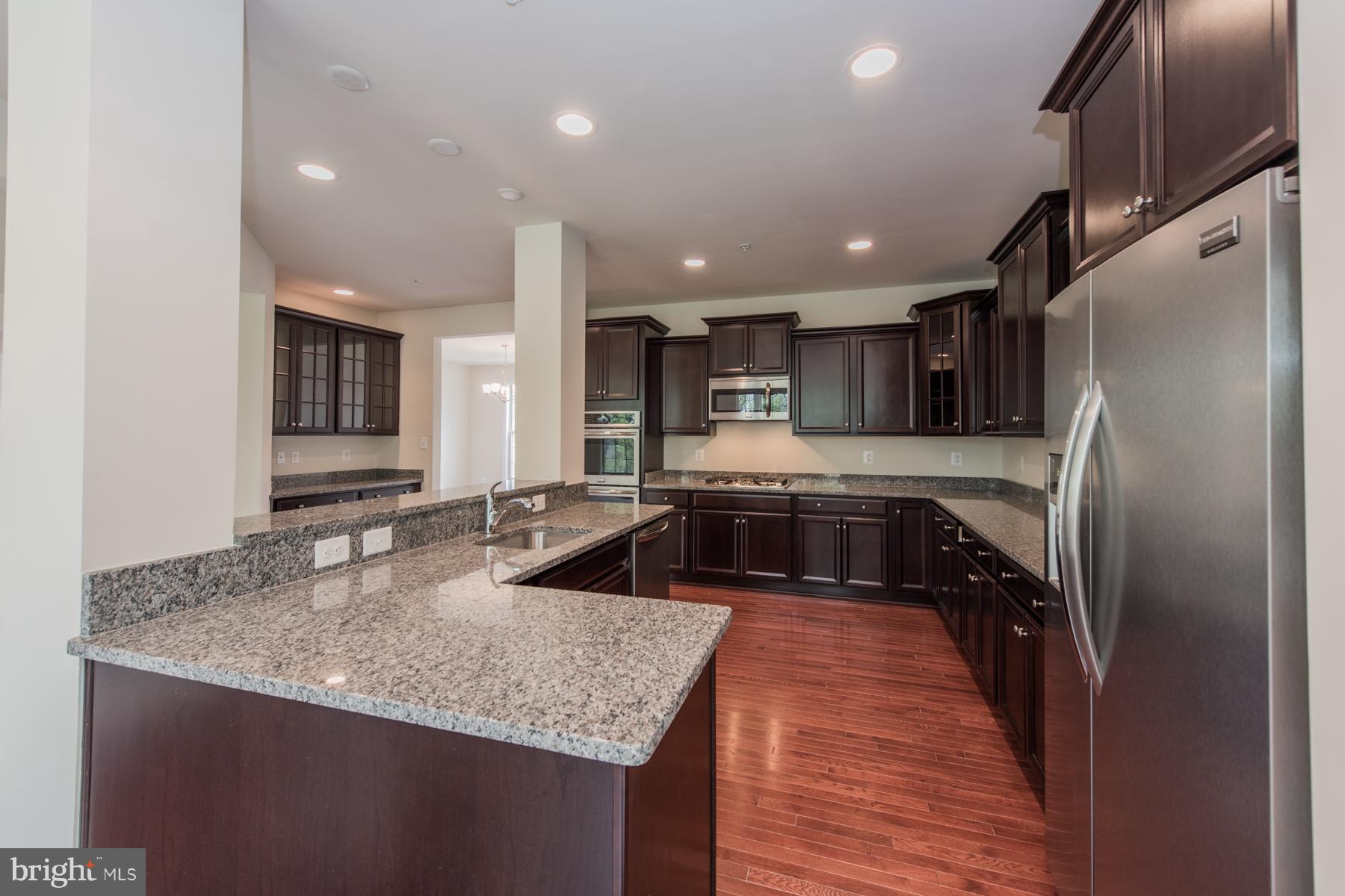 9770 Powder Hall Road Perry Hall, MD 21128 - Photo 14 of 29 a kitchen with stainless steel appliances granite countertop a sink a stove and a refrigerator
