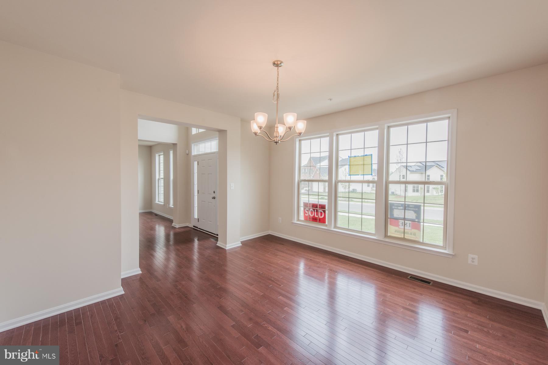 9770 Powder Hall Road Perry Hall, MD 21128 - Photo 8 of 29 a view of an empty room with wooden floor and a window