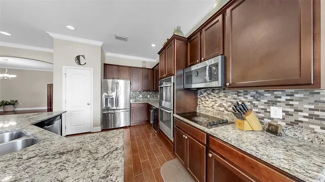 a bedroom with a bed and a flat tv screen on dresser