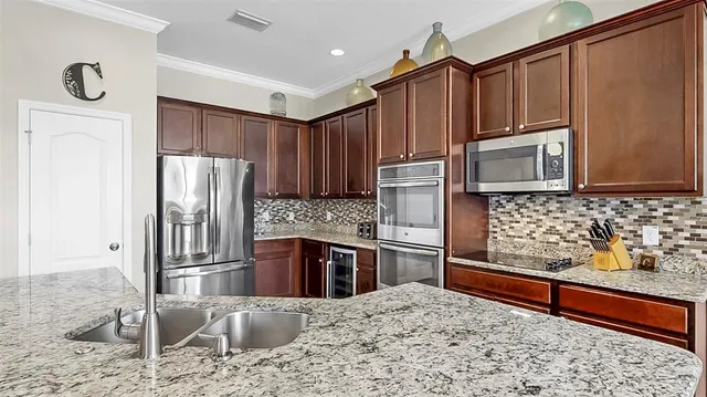 a living room with furniture a flat screen tv and a large window