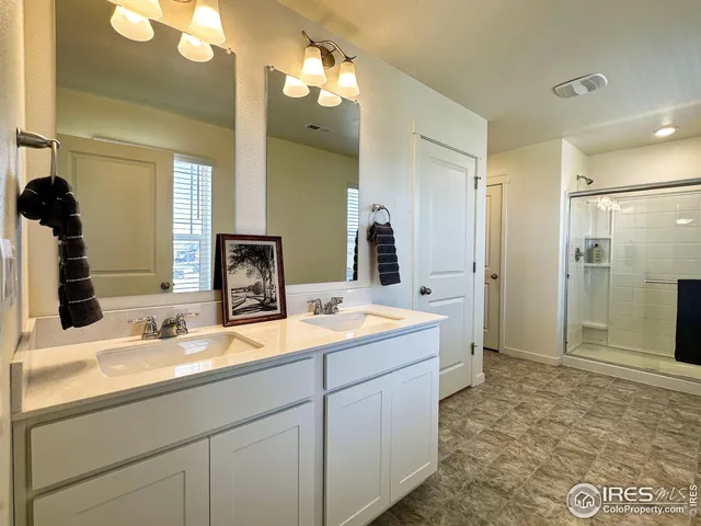 a bathroom with a sink double vanity and a mirror