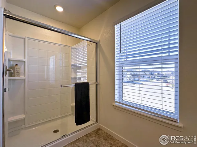 a bathroom with a shower and a window