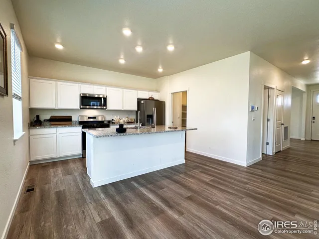 a kitchen with stainless steel appliances a refrigerator sink and microwave