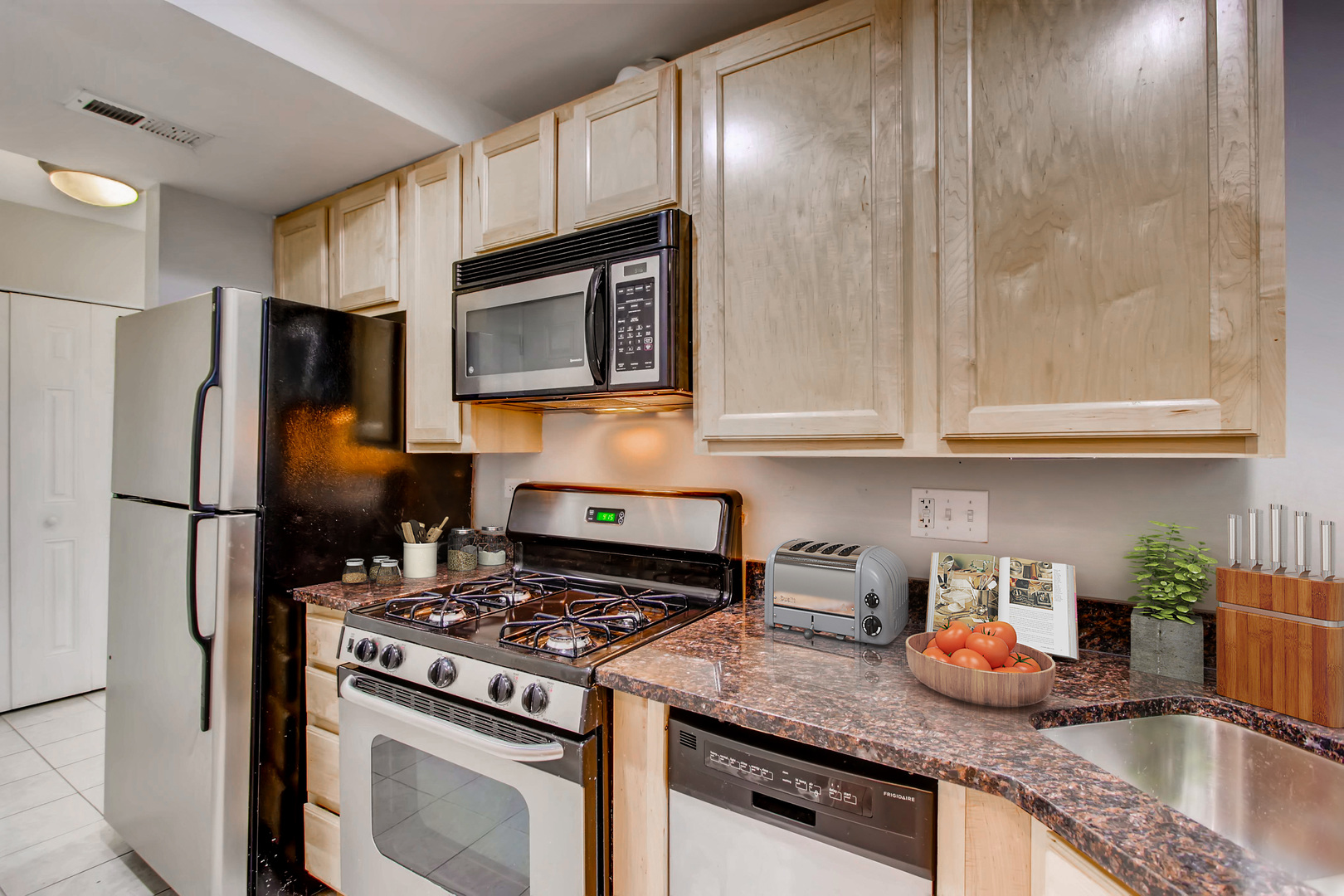 702 Reba Place, Unit G2 Evanston, IL 60202 - Photo 3 of 12 a kitchen with stainless steel appliances granite countertop a sink stove and refrigerator