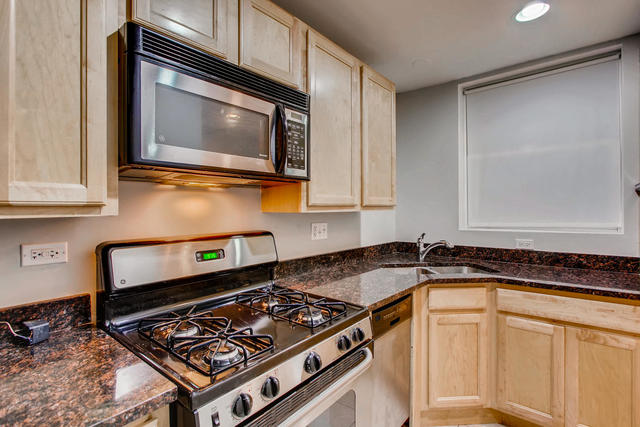 702 Reba Place, Unit G2 Evanston, IL 60202 - Photo 8 of 12 a kitchen with granite countertop a stove and a microwave