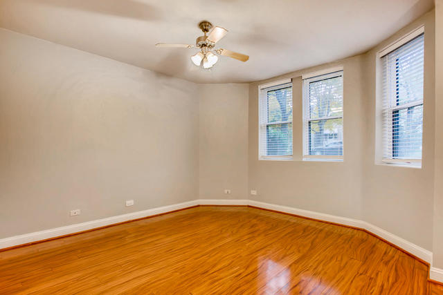 702 Reba Place, Unit G2 Evanston, IL 60202 - Photo 9 of 12 a view of empty room with wooden floor and fan