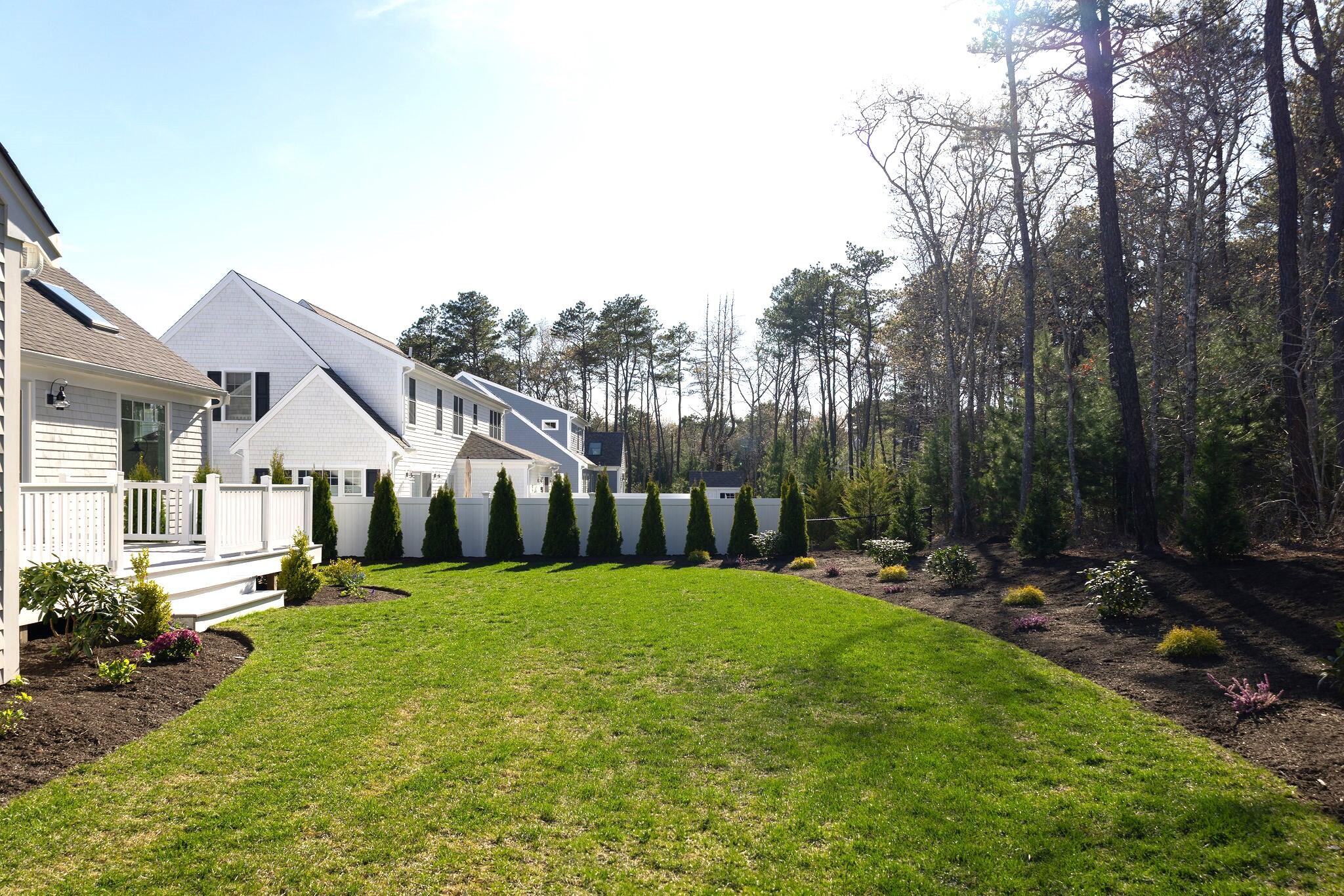 55 Blue Castle Drive Mashpee, MA 02649 - Photo 12 of 52 a backyard of a house with table and chairs