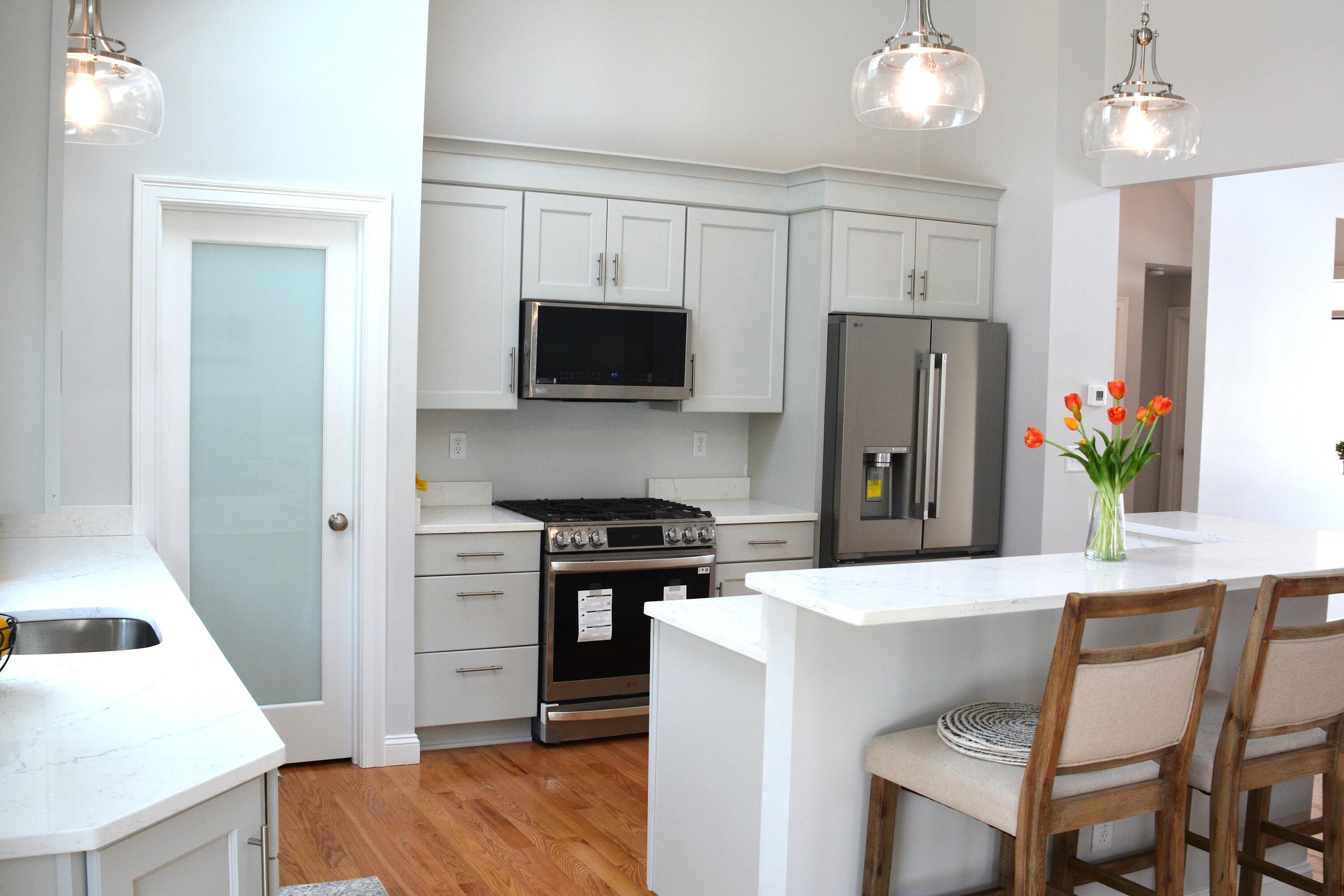 55 Blue Castle Drive Mashpee, MA 02649 - Photo 20 of 52 a kitchen with stainless steel appliances a stove refrigerator sink and microwave