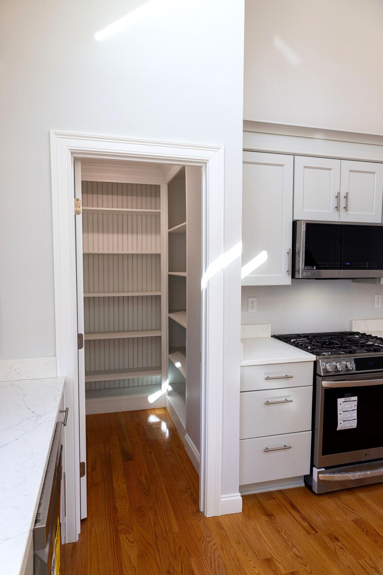 55 Blue Castle Drive Mashpee, MA 02649 - Photo 22 of 52 a kitchen with granite countertop a stove and a wooden floor