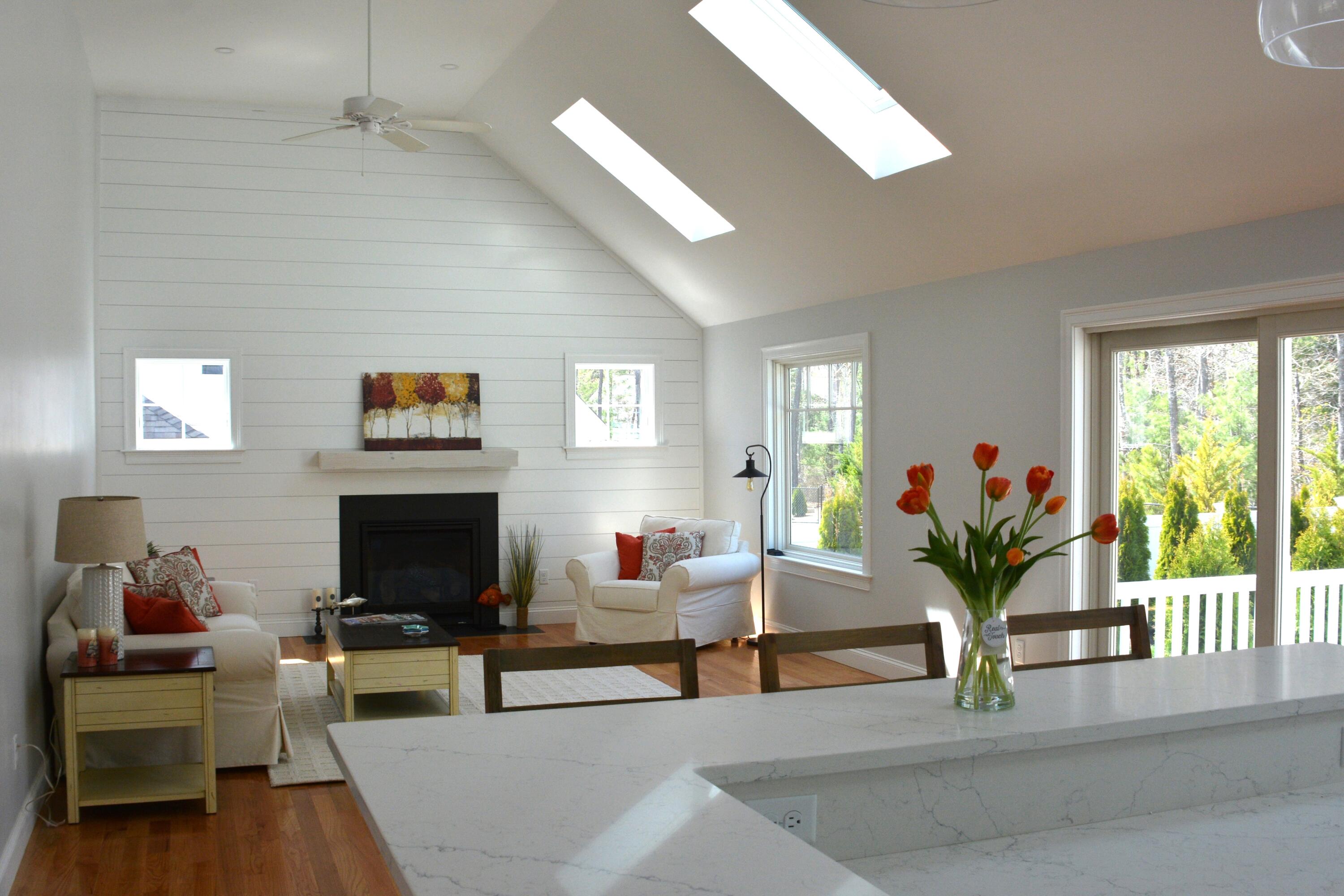55 Blue Castle Drive Mashpee, MA 02649 - Photo 26 of 52 a living room with furniture a fireplace and a potted plant