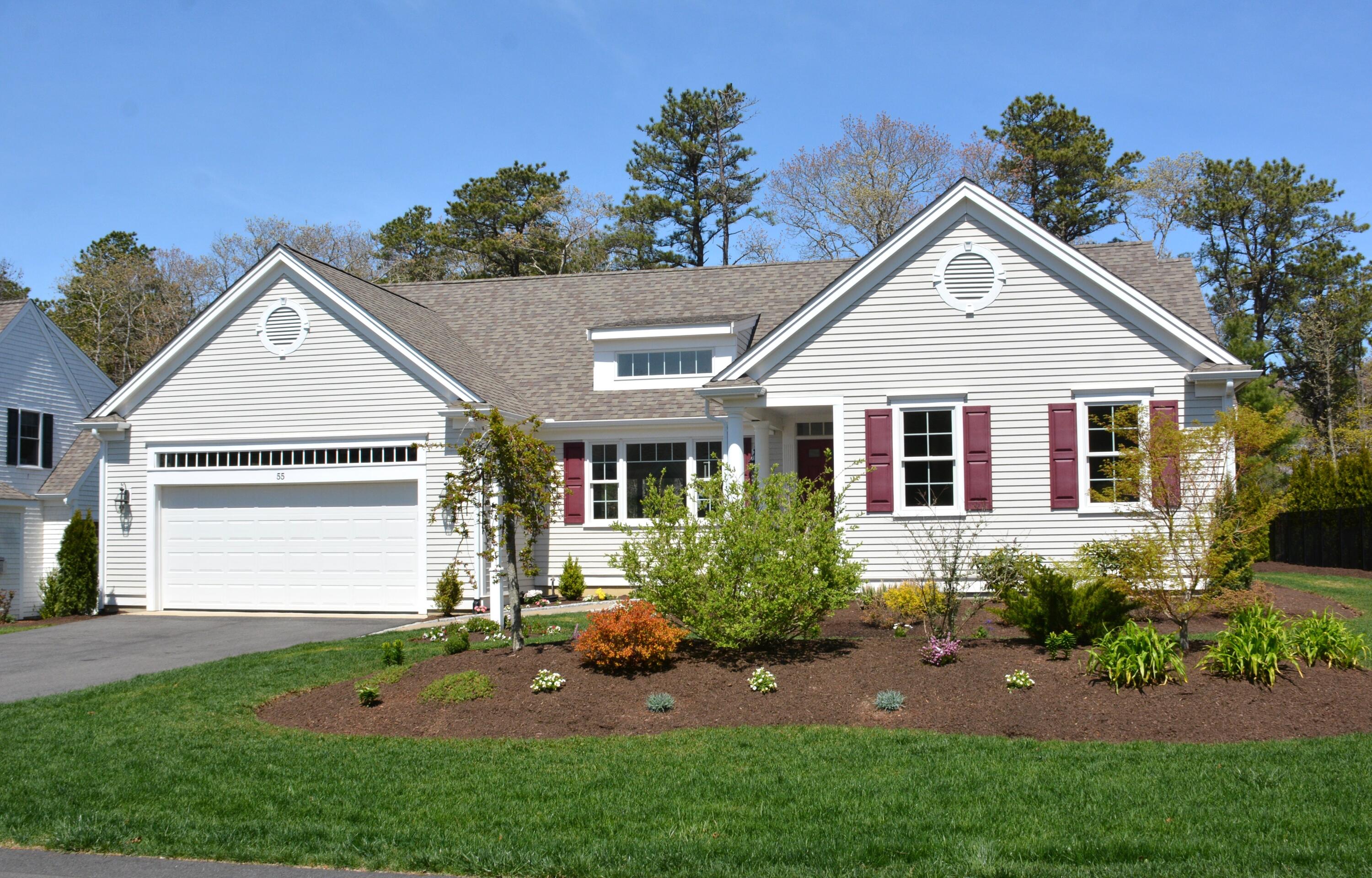 55 Blue Castle Drive Mashpee, MA 02649 - Photo 3 of 52 a front view of a house with a garden