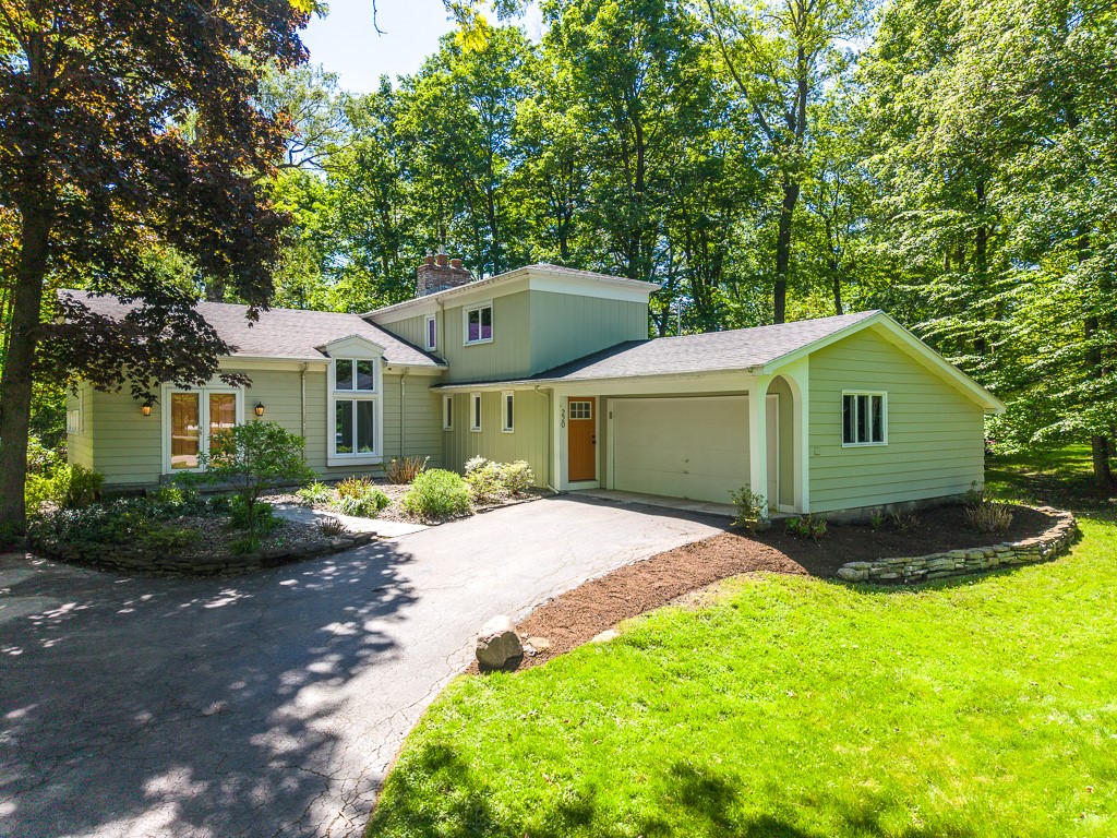Nature frames this experience. Nestled on a lush, tree-filled .6-acre property, this serene setting offers a rare sense of privacy and calm in the heart of Brighton, just moments from Pittsford shops and amenities