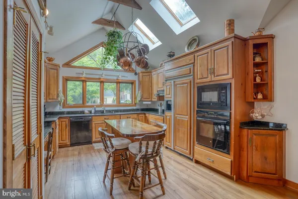 a kitchen with a stove a sink and a cabinets