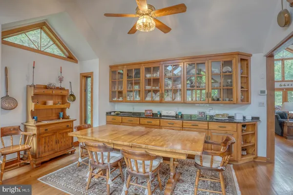a spacious bathroom with a granite countertop sink and a mirror