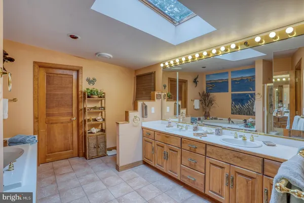 a bedroom with a large bed couch and a window