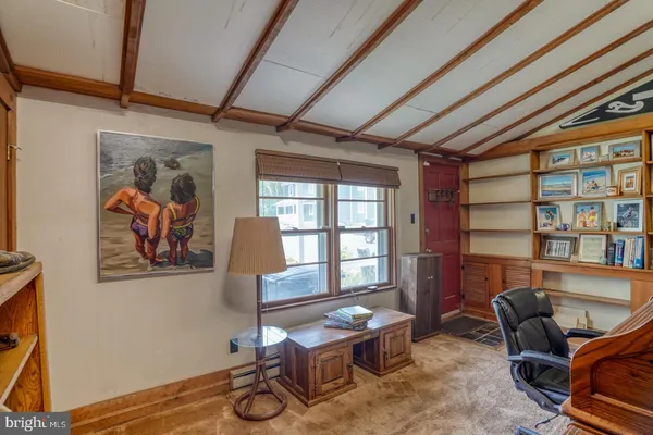 an aerial view of residential house with outdoor space and trees all around