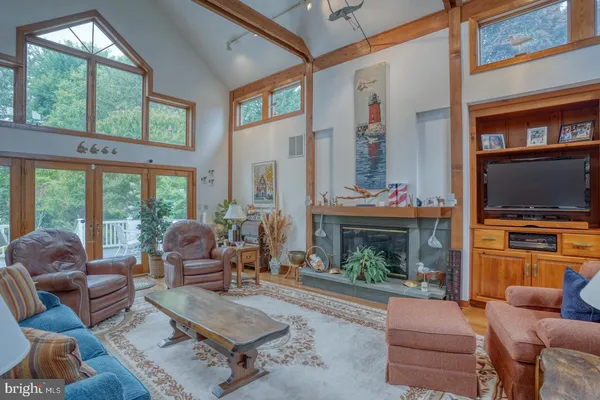 a living room with furniture a fireplace and a wall painting