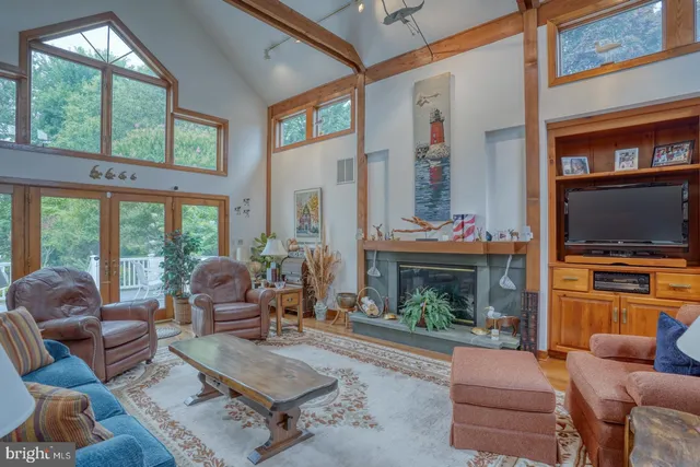 a living room with furniture a fireplace and a wall painting