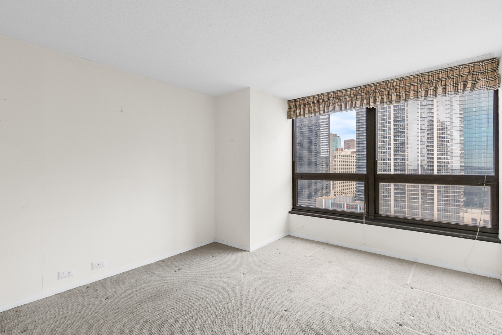 360 East Randolph Street, Unit 2307 Chicago, IL 60601 - Photo 11 of 34 a view of an empty room with a window