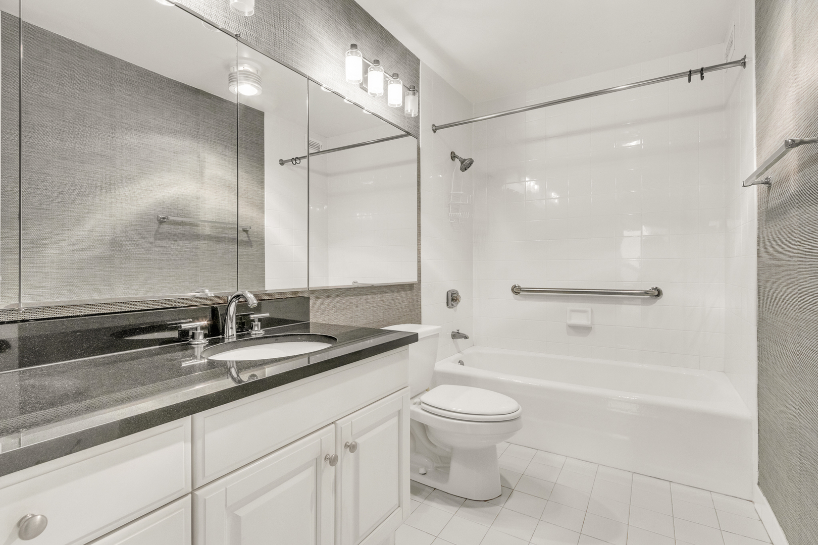 360 East Randolph Street, Unit 2307 Chicago, IL 60601 - Photo 18 of 34 a bathroom with a double vanity sink toilet mirror and shower