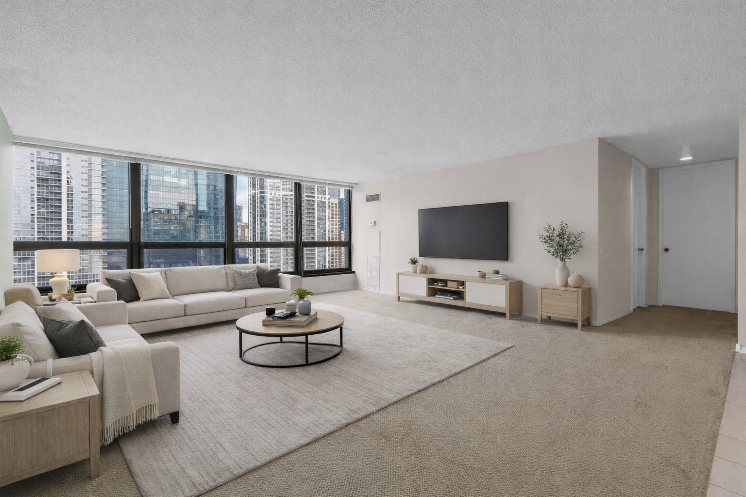 360 East Randolph Street, Unit 2307 Chicago, IL 60601 - Photo 2 of 34 a living room with furniture and a flat screen tv