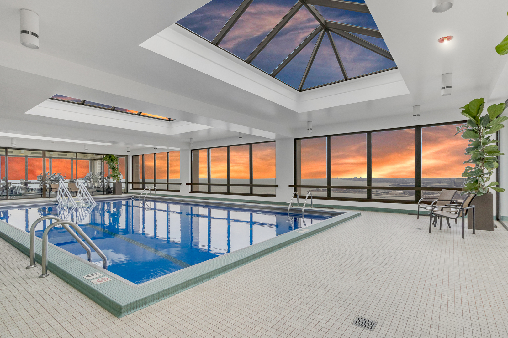 360 East Randolph Street, Unit 2307 Chicago, IL 60601 - Photo 27 of 34 a view of a kitchen with furniture and a flat screen tv